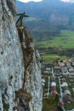 Mountain guide showing the view from via ferrata Grančišče above village Mojstrana.