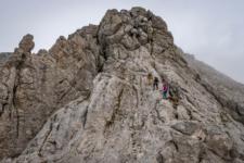 Guide with two climbers before the top of the mountain in Kamnik Savinja AlpsGuide with two climbers before the top of the mountain in Kamnik Savinja Alps